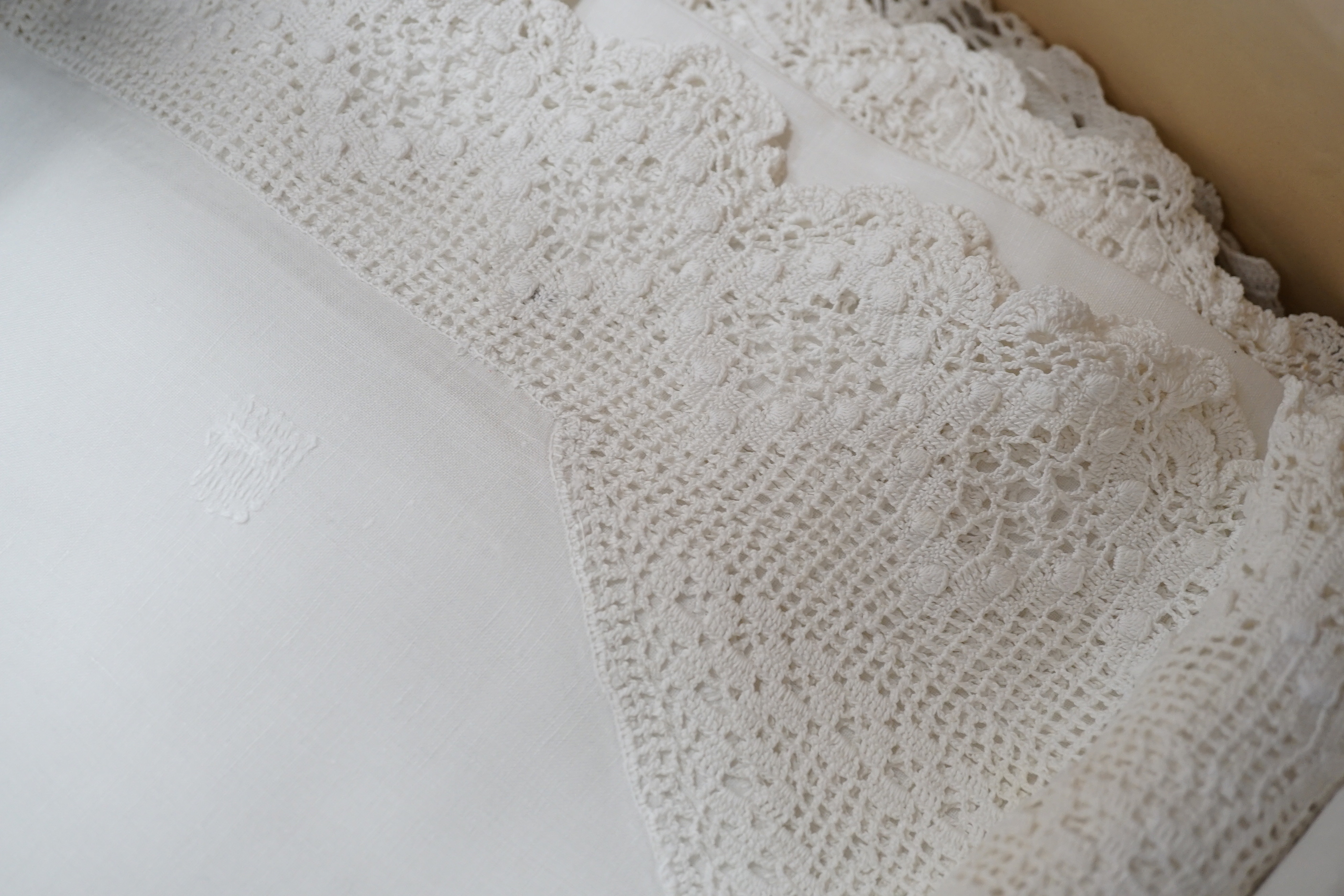 A collection of linen crochet and tape lace edged table cloths